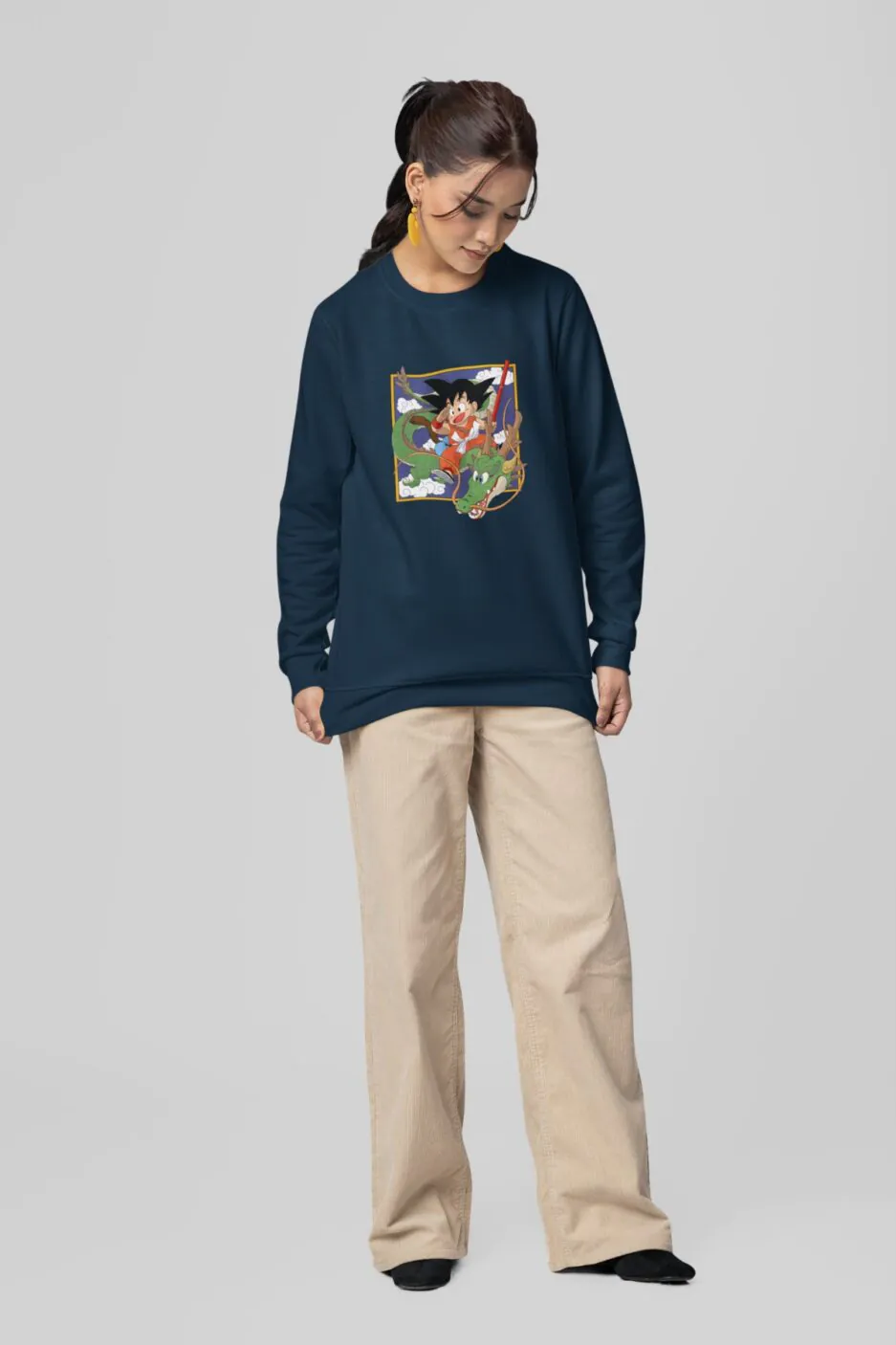 Woman wearing a navy blue sweatshirt with Goku and Shenron Dragon Ball Daima design.
